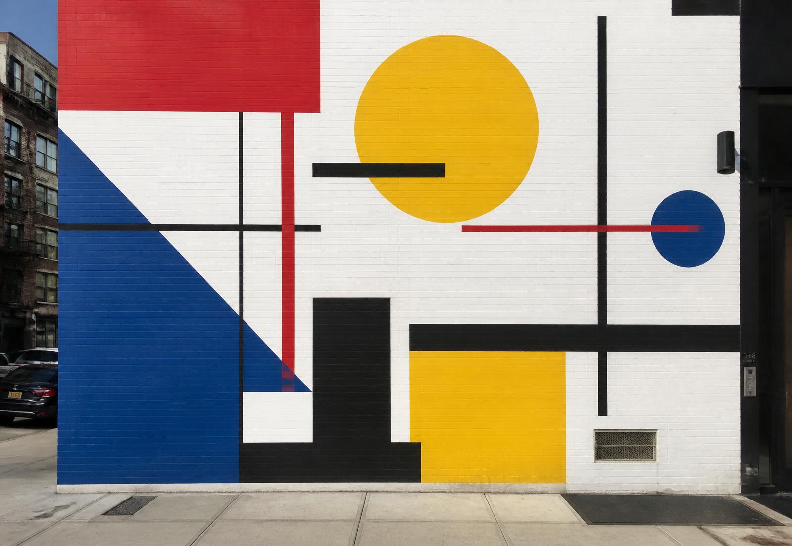 Large Bauhaus geometric mural painted on a city building wall
